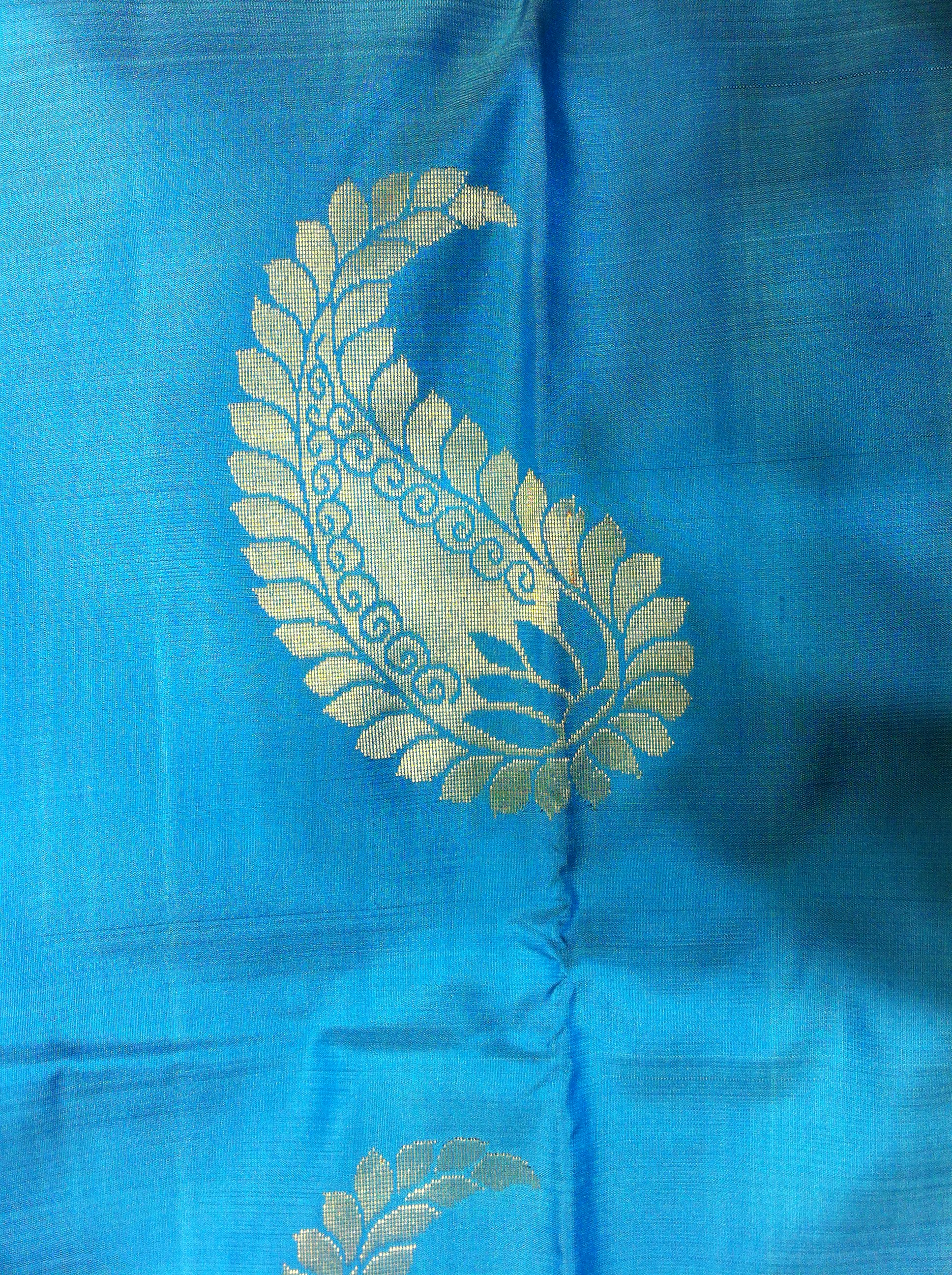 A gold mango-shaped maanga motif woven into blue Kanchipuram silk